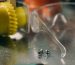 Detailed close-up of safety glasses and screws on a metal surface in a workshop setting.