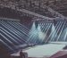 An expansive indoor stage with dramatic lighting setup, ready for a performance or event.